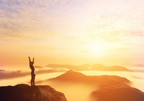 person watching sunrise on mountain